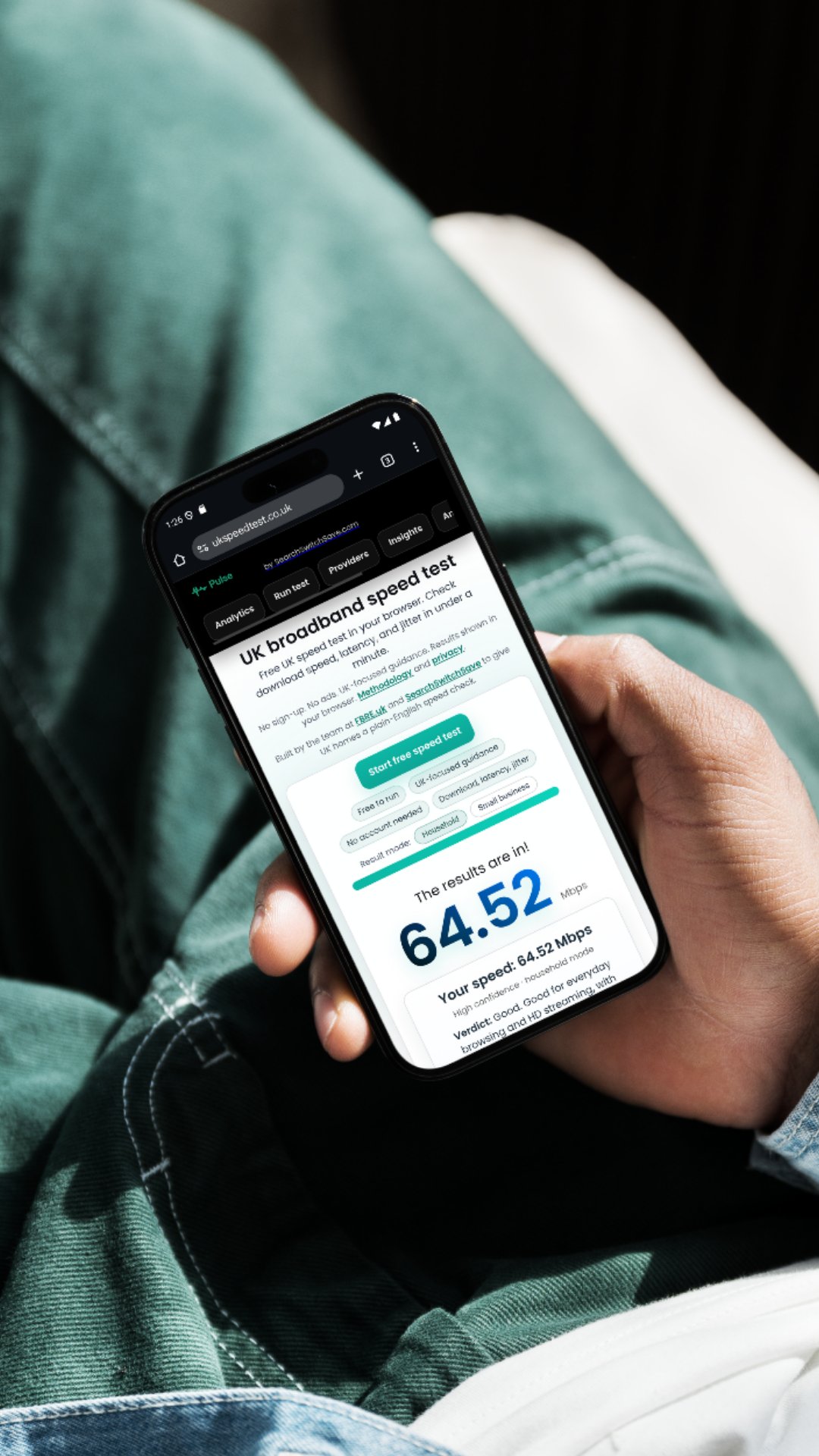 Sister-site fairness check: UKSpeedTest.co.uk by SearchSwitchSave A person checking their UK broadband speed using UKSpeedTest.co.uk on a smartphone, showing a download speed of 64.52 Mbps